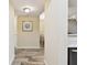 Inviting hallway with wood-look tile flooring, leading to the dining area at 1231 Godavari Way # 103, Wesley Chapel, FL 33543