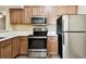 A modern kitchen featuring stainless steel appliances and ample cabinet space at 1231 Godavari Way # 103, Wesley Chapel, FL 33543