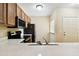 Bright kitchen showcasing sleek countertops, stainless steel appliances, and an abundance of natural light at 1231 Godavari Way # 103, Wesley Chapel, FL 33543