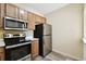 Efficient kitchen design with stainless steel appliances and ample cabinet space at 1231 Godavari Way # 103, Wesley Chapel, FL 33543