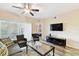 Living room featuring modern decor, patio access, and entertainment center at 1231 Godavari Way # 103, Wesley Chapel, FL 33543