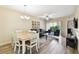 Open-concept living and dining area featuring wood-look tile and abundant natural light at 1231 Godavari Way # 103, Wesley Chapel, FL 33543