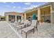 Outdoor lounge area featuring ample seating, ceiling fans, and covered patio for relaxing or entertaining at 1231 Godavari Way # 103, Wesley Chapel, FL 33543