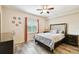 Cozy main bedroom features wood-look flooring and a bright, sunny window at 1231 Godavari Way # 103, Wesley Chapel, FL 33543