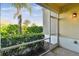 The screened lanai has a serene view of the landscaped backyard at 1231 Godavari Way # 103, Wesley Chapel, FL 33543