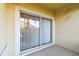 Enclosed lanai with sliding glass door and exterior view at 1231 Godavari Way # 103, Wesley Chapel, FL 33543