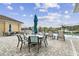 Lounge and dining area by a luxurious pool overlooking a scenic pond, offering serene relaxation at 1231 Godavari Way # 103, Wesley Chapel, FL 33543