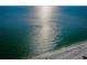 Expansive ocean view, shimmering water, and a pristine white sand beach on a sunny day at 12409 Gulf Blvd, Treasure Island, FL 33706