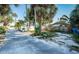 Street view of a neighborhood featuring an alley and landscaping at 12409 Gulf Blvd, Treasure Island, FL 33706
