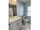 Bright bathroom featuring white vanity with quartz countertops, and a window at 12447 Drysdale St, Spring Hill, FL 34609