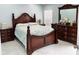 Elegant bedroom with a classic wooden bed frame and matching dresser at 12447 Drysdale St, Spring Hill, FL 34609