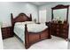 Elegant bedroom with a classic wooden bed frame and matching dresser at 12447 Drysdale St, Spring Hill, FL 34609