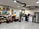 Spacious garage provides ample storage and workspace, featuring shelving and household appliances at 12447 Drysdale St, Spring Hill, FL 34609