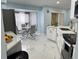 Modern kitchen with sleek marble floors, white cabinetry, and stainless steel appliances at 12447 Drysdale St, Spring Hill, FL 34609