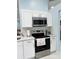 Modern kitchen featuring stainless steel appliances, white cabinets, and beautiful countertops at 12447 Drysdale St, Spring Hill, FL 34609