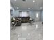 Inviting living room with neutral color palette, marble floors, and modern furnishings at 12447 Drysdale St, Spring Hill, FL 34609