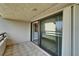 Tiled balcony with sliding glass doors offering serene views and ample natural light at 126 1St E St # 102, Tierra Verde, FL 33715