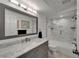 Beautifully renovated bathroom with a modern vanity and a sleek glass-enclosed shower and tub at 126 1St E St # 102, Tierra Verde, FL 33715