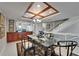 Bright dining room boasts a glass table set and stylish seating, adjacent to an open kitchen area at 126 1St E St # 102, Tierra Verde, FL 33715