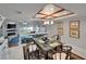 Inviting dining room with a glass table, open layout, scenic view, and stylish decor with a fireplace at 126 1St E St # 102, Tierra Verde, FL 33715