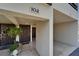 Front door with tile entryway, decorative plant, welcome mat and an attached garage at 126 1St E St # 102, Tierra Verde, FL 33715