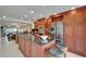 Open concept kitchen with granite island, stainless steel appliances, wine rack, and bar stool seating at 126 1St E St # 102, Tierra Verde, FL 33715