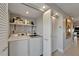 Efficient laundry room with updated washer and dryer, ample shelving, and storage for added convenience at 126 1St E St # 102, Tierra Verde, FL 33715
