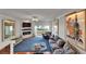 Cozy living room featuring a fireplace, balcony access and vintage posters for a sophisticated touch at 126 1St E St # 102, Tierra Verde, FL 33715