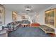 Well-appointed living space with a cozy sofa, vintage posters, and staircase leading to upper level at 126 1St E St # 102, Tierra Verde, FL 33715