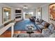 Elegant living room boasting a fireplace, balcony with water views, and a comfortable seating arrangement at 126 1St E St # 102, Tierra Verde, FL 33715