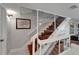 Modern staircase with glass panels, hardwood steps, and white risers, offers a sleek transition at 126 1St E St # 102, Tierra Verde, FL 33715