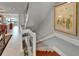 Elegant staircase with glass panels and a light-filled open design adjacent to the dining area at 126 1St E St # 102, Tierra Verde, FL 33715