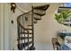 Spiral staircase leads to the patio, offering a unique design element at 126 1St E St # 102, Tierra Verde, FL 33715