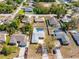 Aerial view of neighborhood showcasing mature trees and houses with private pools at 14136 Payne St, Spring Hill, FL 34609