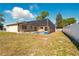 Backyard view of a screened in pool and patio surrounded by a privacy fence at 14136 Payne St, Spring Hill, FL 34609