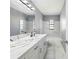 Bathroom featuring marble tiling, granite vanity, and a large mirror at 14136 Payne St, Spring Hill, FL 34609