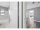 View of bathroom with marble tiling, white bathtub, and sink with modern fixtures at 14136 Payne St, Spring Hill, FL 34609