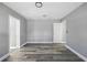 A large empty bedroom with wood floors, neutral walls, and two doorways at 14136 Payne St, Spring Hill, FL 34609
