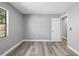 A bright bedroom showcasing wood floors and natural light from the window at 14136 Payne St, Spring Hill, FL 34609