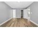 Bedroom with neutral walls, closet and bathroom access and wood-look flooring at 14136 Payne St, Spring Hill, FL 34609