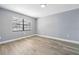 Bright bedroom with gray walls, wood-look flooring, and natural light from a large window at 14136 Payne St, Spring Hill, FL 34609