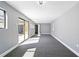 Spacious bonus room with new carpet and sliding glass doors that provide ample natural light at 14136 Payne St, Spring Hill, FL 34609
