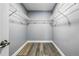 Walk-in closet with wood floors, wire shelving, and ample storage space at 14136 Payne St, Spring Hill, FL 34609