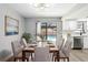 Dining area with modern decor, backyard pool view, and natural light at 14136 Payne St, Spring Hill, FL 34609