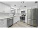 Modern kitchen with stainless steel appliances, white cabinets, and updated countertops at 14136 Payne St, Spring Hill, FL 34609