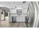 Modern kitchen with white cabinetry, stainless steel appliances, and view of the backyard pool at 14136 Payne St, Spring Hill, FL 34609