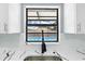 Bright kitchen with modern black faucet, marble countertops, and a pool view at 14136 Payne St, Spring Hill, FL 34609