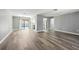 Bright living area with luxury vinyl plank flooring that opens to a pool and kitchen featuring stainless steel appliances at 14136 Payne St, Spring Hill, FL 34609