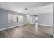 Bright and airy room with luxury vinyl flooring, neutral gray walls, and large windows for natural light at 14136 Payne St, Spring Hill, FL 34609