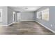 Open living space with sleek luxury vinyl flooring, neutral gray walls, and bright, natural light at 14136 Payne St, Spring Hill, FL 34609